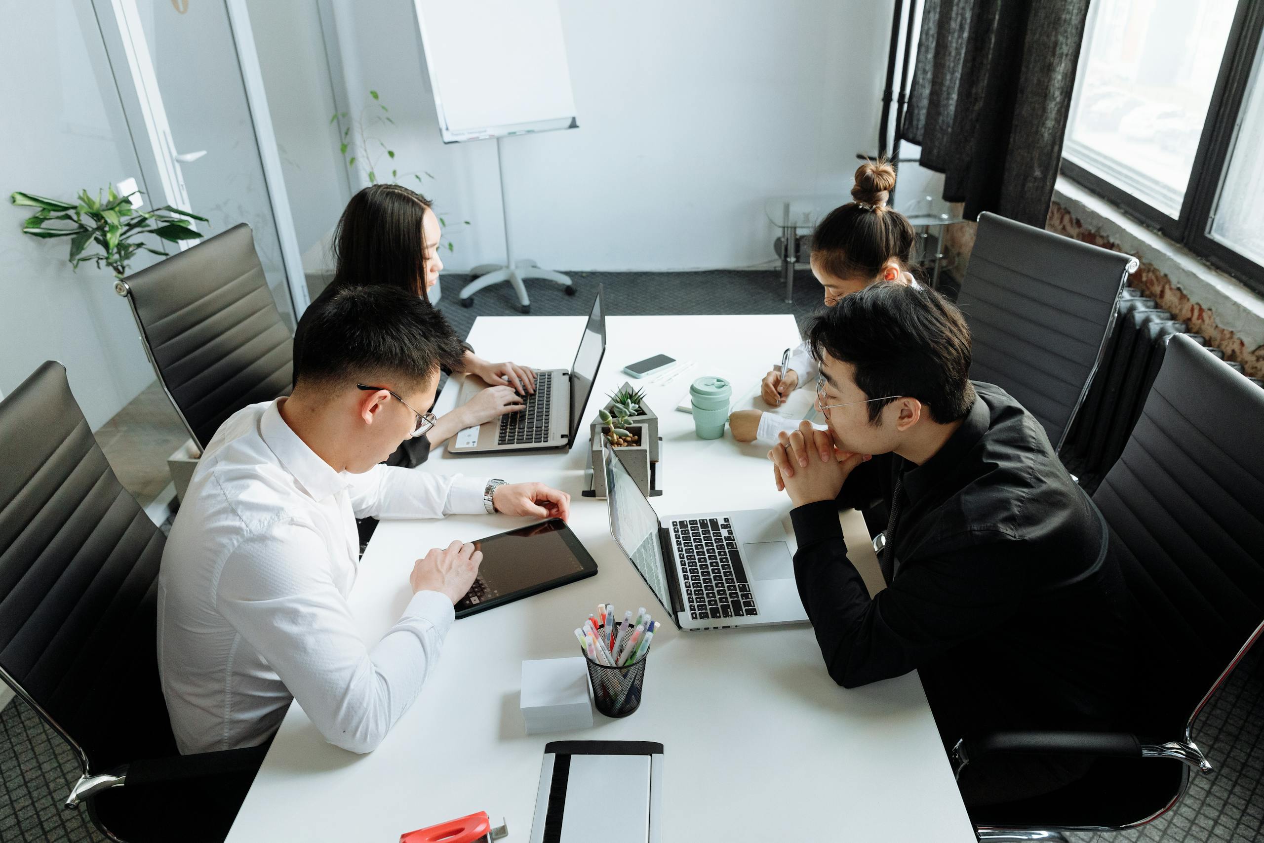 A Group of People Having a Meeting in the Office